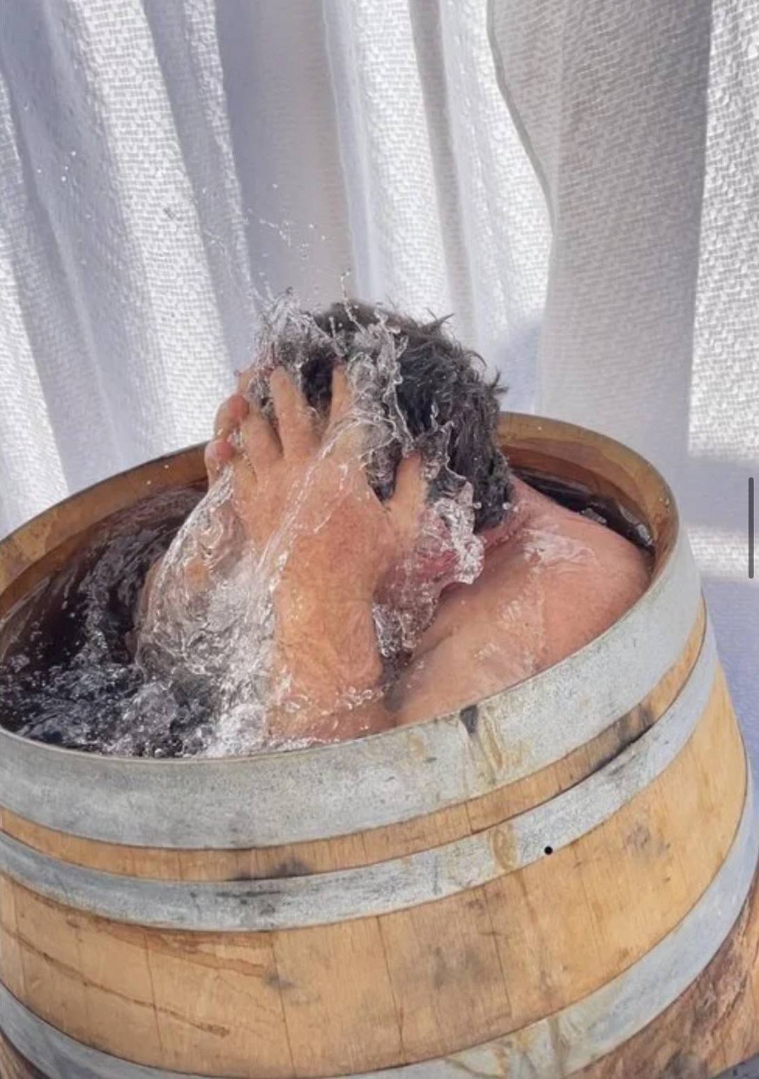Cold water thrown back over the head in the plunge barrel